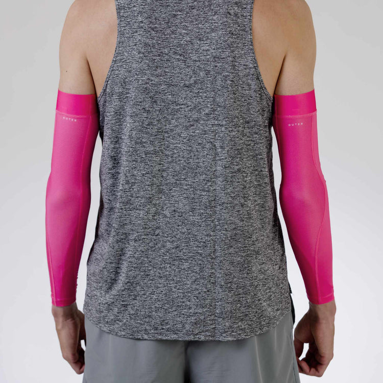 Rear view of outstanding neon pink arm warmers by WASP Aerodynamics, highlighting their vibrant color and sleek fit.