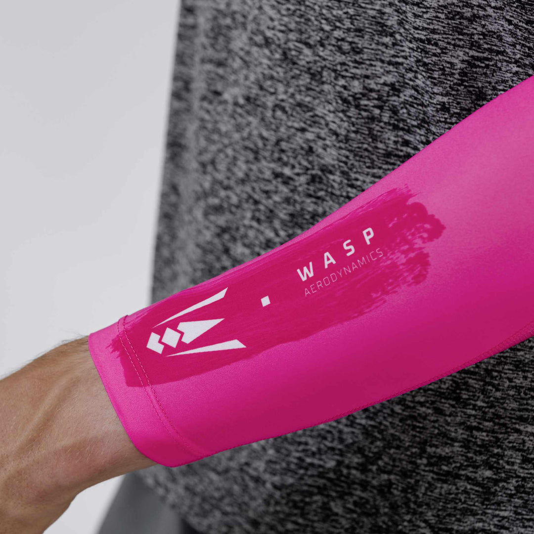 Close-up of the Wasp Aerodynamics logo on the striking pink performance arm sleeve, designed for athletes to enhance speed and comfort.