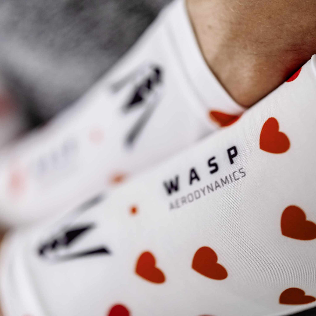 Close-up of a heart-patterned arm sleeve, featuring vibrant, dynamic designs that embrace the perfect running outfit.