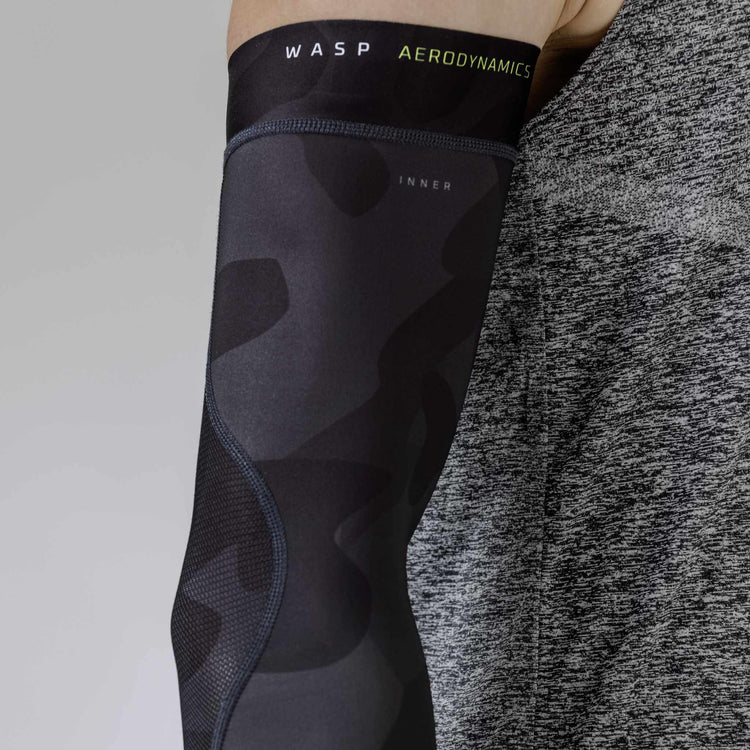 Masculine dark camo arm sleeve by WASP Aerodynamics, featuring a sleek, dark camouflage design for durability and athletic performance.