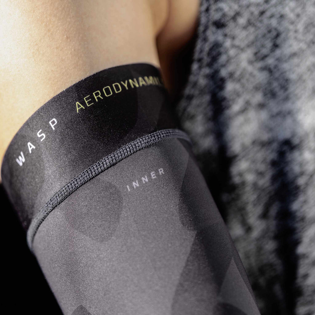 Close-up of the precisely printed WASP Aerodynamics logo on arm sleeve, showcasing detailed craftsmanship and premium branding.