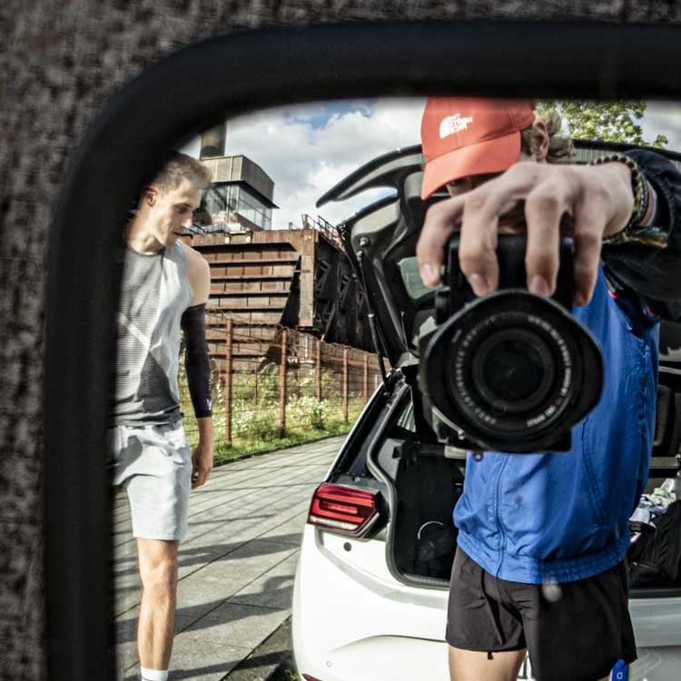 A mirror selfie taken with a camera showing two runners.